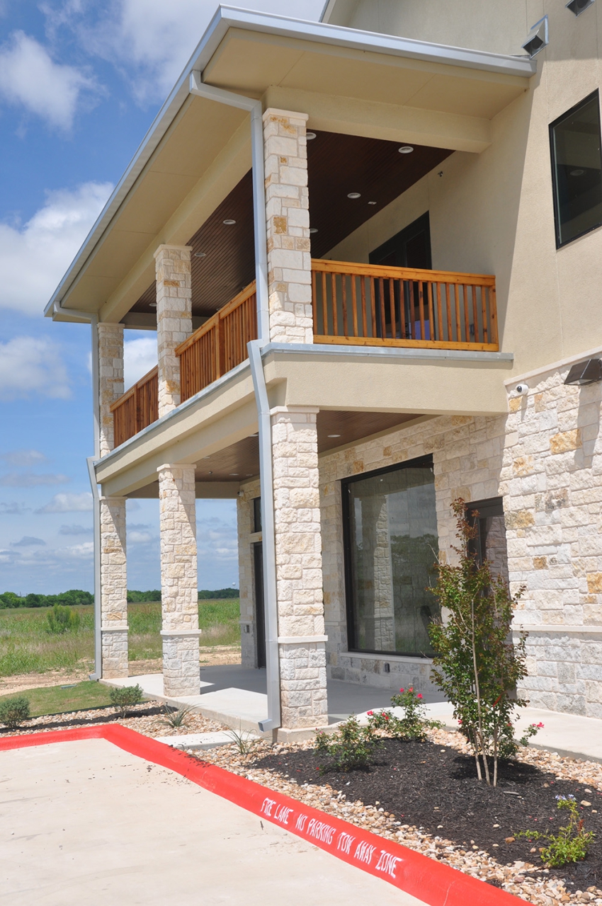 Outdoor photo of the side of a 2 story commercial building with custom decking. Commercial Construction Contracting by SB Thompson Construction in San Marcos, Texas