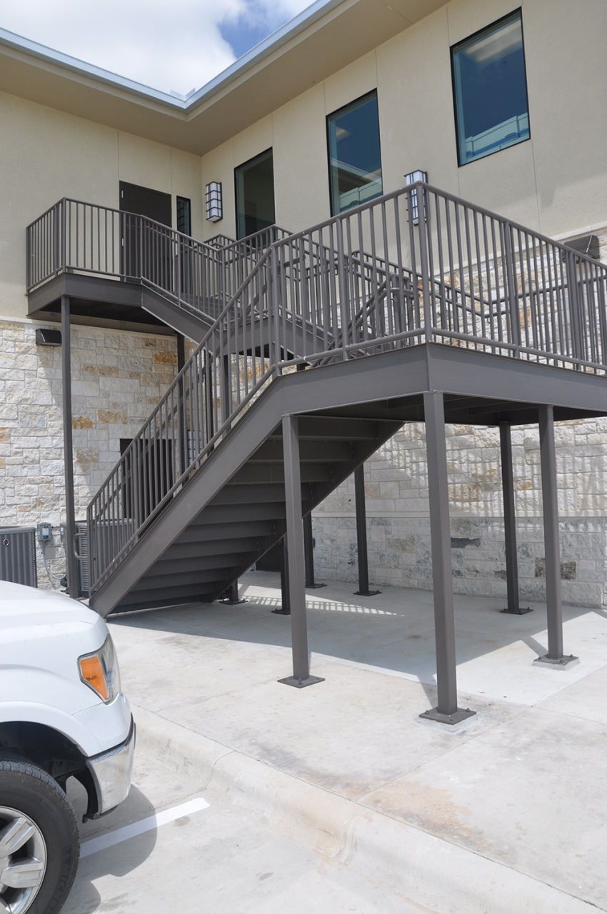Outdoor photo of the side of a 2 story commercial building with metal stairway. Commercial Construction Contracting by SB Thompson Construction in San Marcos, Texas