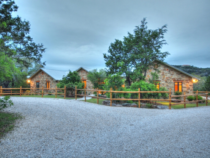 Ranch style house with gravel driveway and nice landscaping in Wimberley Valley.
