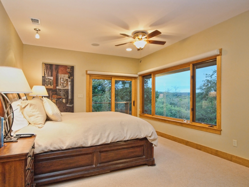 Bedroom of custom home in Central Texas. Windows looking out on the Texas Hill Country.