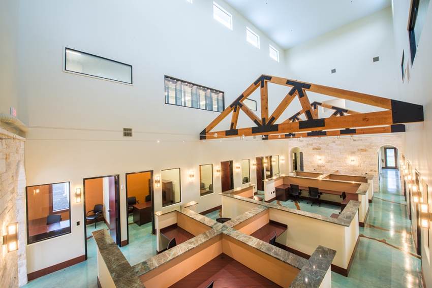 Commercial Construction, in Central Texas. Two story open layout with custom built in desks, granite counter tops, and a custom green, exposed beams, and gold apoxy floor.