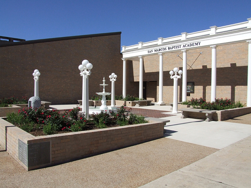Remembrance gardens built for San Marcos Academy by contractors managed by SB Thomspson construction. Stone and concrete pathways, tall white columns, a decorative white fountain, white lighting and rose garden.