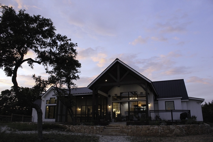 Custom Home modern farmhouse full view of front with sunset. Built in Wimberley, Texas by S.B. Thompson Construction
